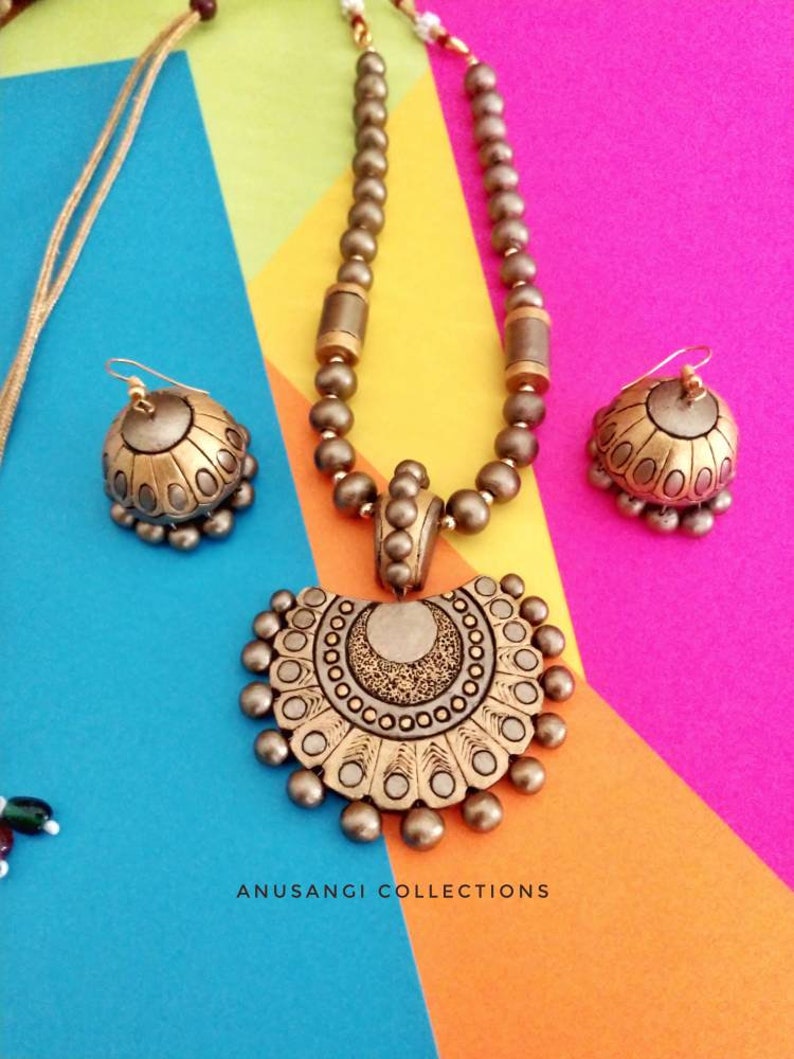 The Damayanti Mala Terracotta Jewelry set features stunning antique terracotta jewelry. Handcrafted with precision and care, this jewelry set showcases the rich cultural heritage of terracotta art. Elevate your style with this unique and timeless set that is sure to make a statement.