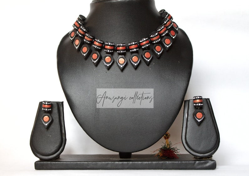 Black Beauty Choker Necklace is a marvelous handmade terracotta necklace with a nice pair of earrings that will add final touch to your outfit. The choker length is well suited for wear with crew collars and high necklines. This product is handmade with love and attention, not mass-produced. Gifts that are handmade with love are the best gifts to give. 