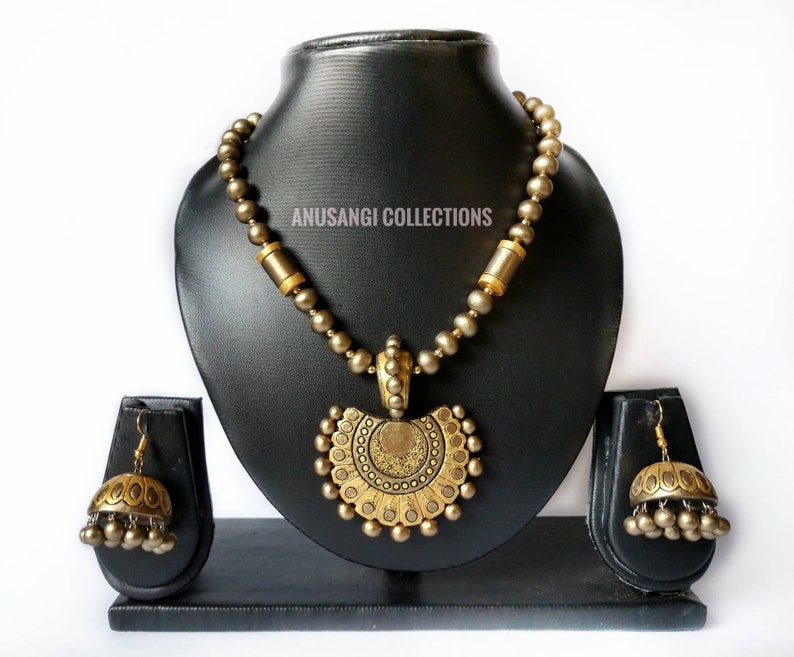 The Damayanti Mala Terracotta Jewelry set features stunning antique terracotta jewelry. Handcrafted with precision and care, this jewelry set showcases the rich cultural heritage of terracotta art. Elevate your style with this unique and timeless set that is sure to make a statement.