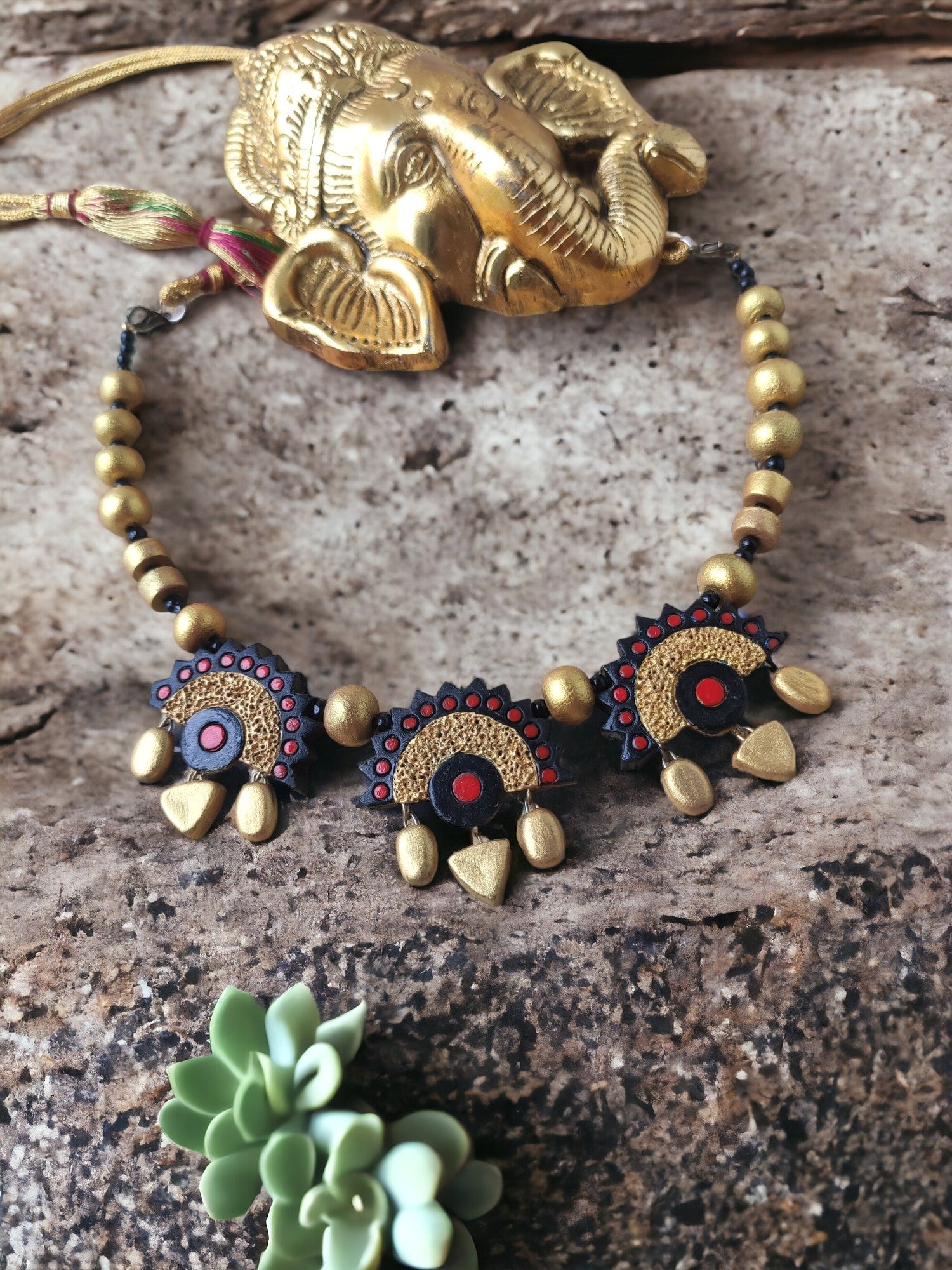 Experience true artistry with our Golden and Black Necklace Set! Handmade with care and attention to detail, this unique design is sure to captivate and inspire.