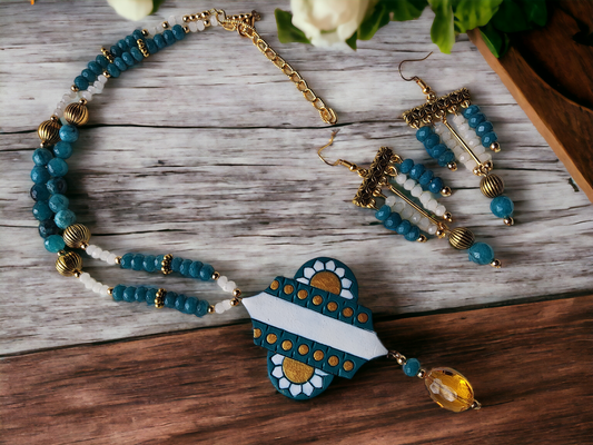 Discover the intricate beauty of the Advika Terracotta jewelry set. Handmade with a Terracotta pendant, Agate and onyx beads, and metal beads, this set boasts a unique blend of craftsmanship and elegant design. Elevate your style with this one-of-a-kind jewelry set.