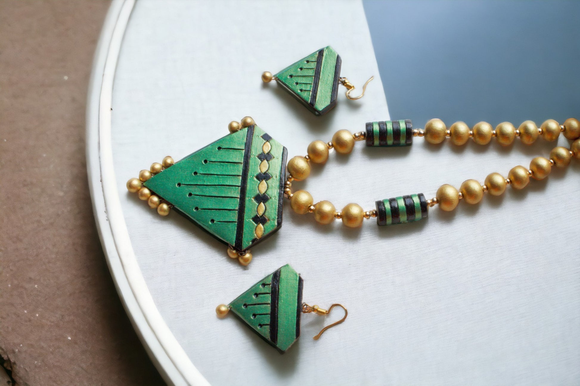 <p data-mce-fragment="1">Unleash your inner celestial maiden with our Janani Terracotta Jewelry set. Delightfully handmade with love and attention, this necklace and earring set features a heavenly green and gold color combination. Perfect for both formal and casual wear, it's a great gift for someone you love or even for yourself!</p>