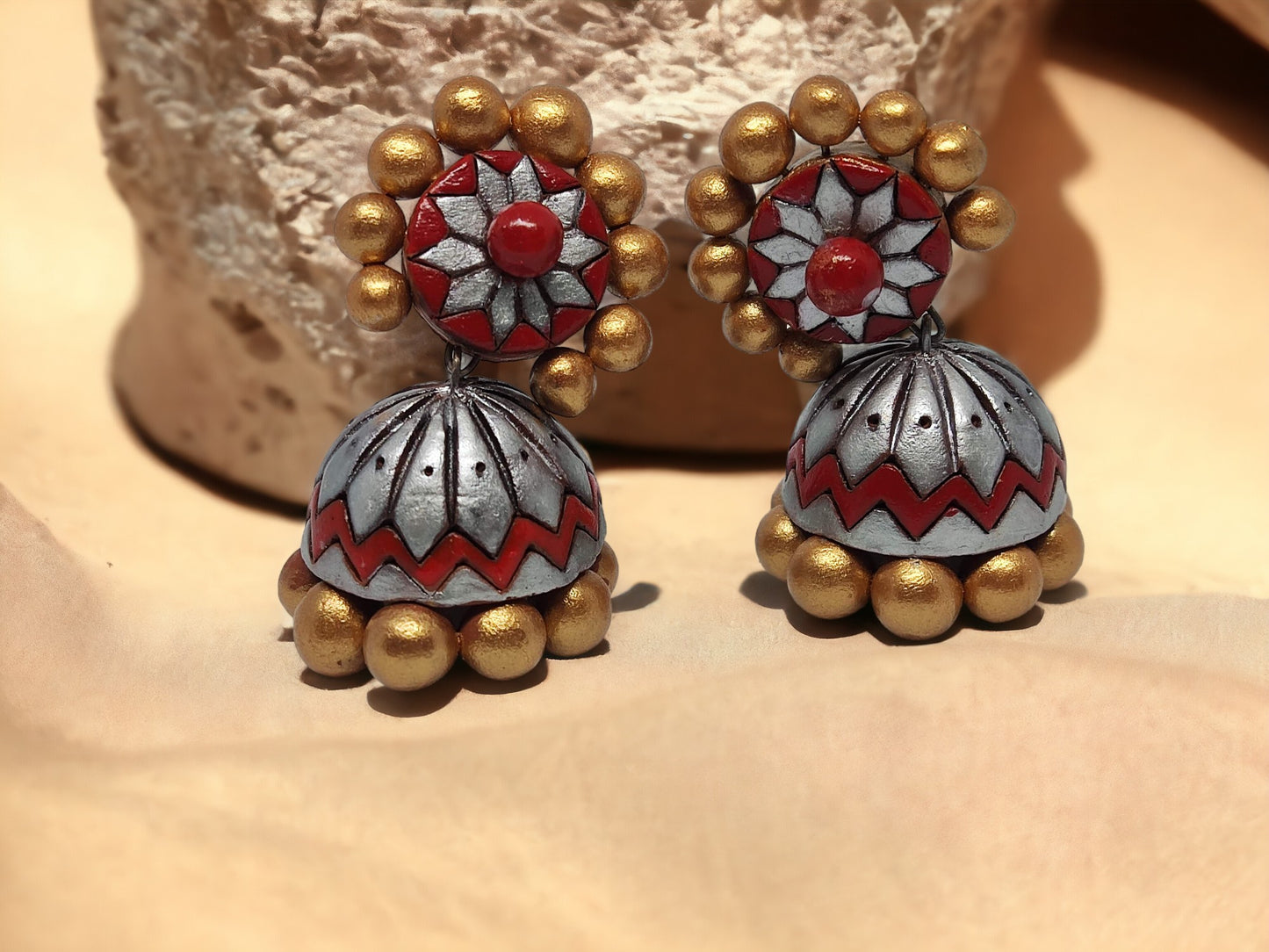 <p data-mce-fragment="1">Elevate your style with Aamodini Terracotta Jhumkas, inspired by nature and made from natural earthen clay. These handcrafted earrings from anusangicollections are perfect for those with metal allergies, as they are skin-friendly. Add a touch of elegance to any outfit with our color-customizable jhumkas.</p>