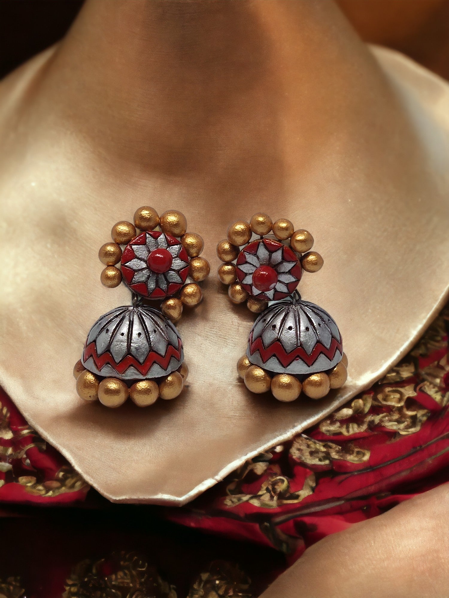 <p data-mce-fragment="1">Elevate your style with Aamodini Terracotta Jhumkas, inspired by nature and made from natural earthen clay. These handcrafted earrings from anusangicollections are perfect for those with metal allergies, as they are skin-friendly. Add a touch of elegance to any outfit with our color-customizable jhumkas.</p>