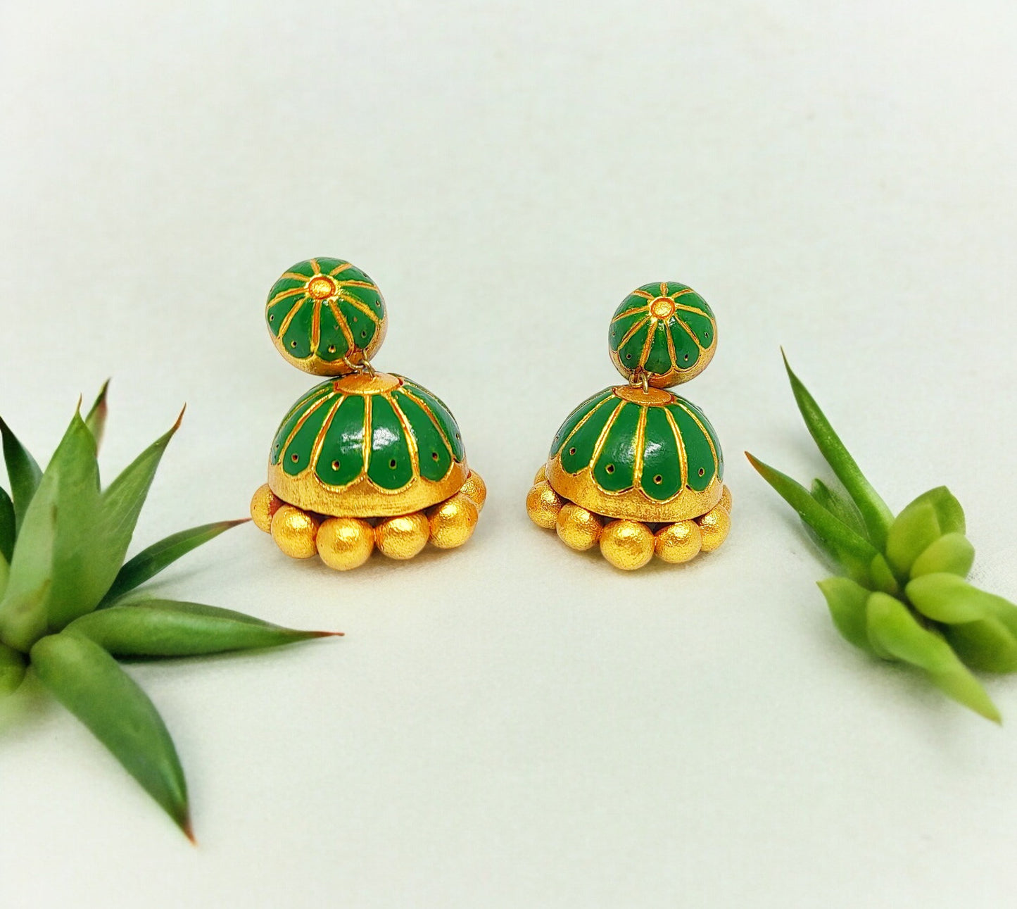 <p data-mce-fragment="1">Handcrafted with 100% care and attention to detail, the Laavanya Green Jhumka is a unique piece of jewelry. No molds were used in its creation, making each piece truly one-of-a-kind. Elevate your style with this handmade accessory.</p>