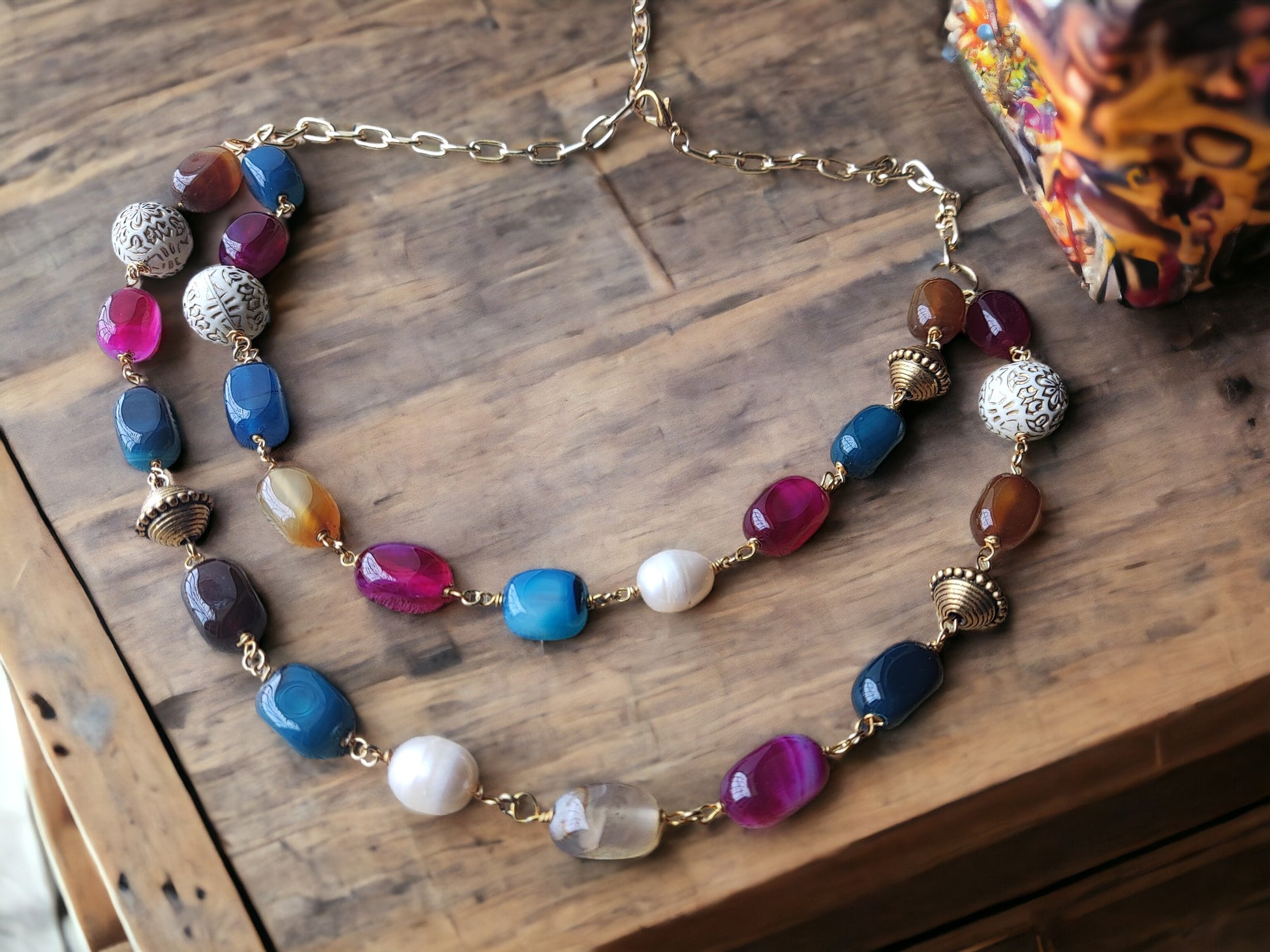 Indulge in the luxurious beauty of our Multi Color Agate Beaded Earrings, featuring stunning pearl and metal accents on a double-layered jewelry set.