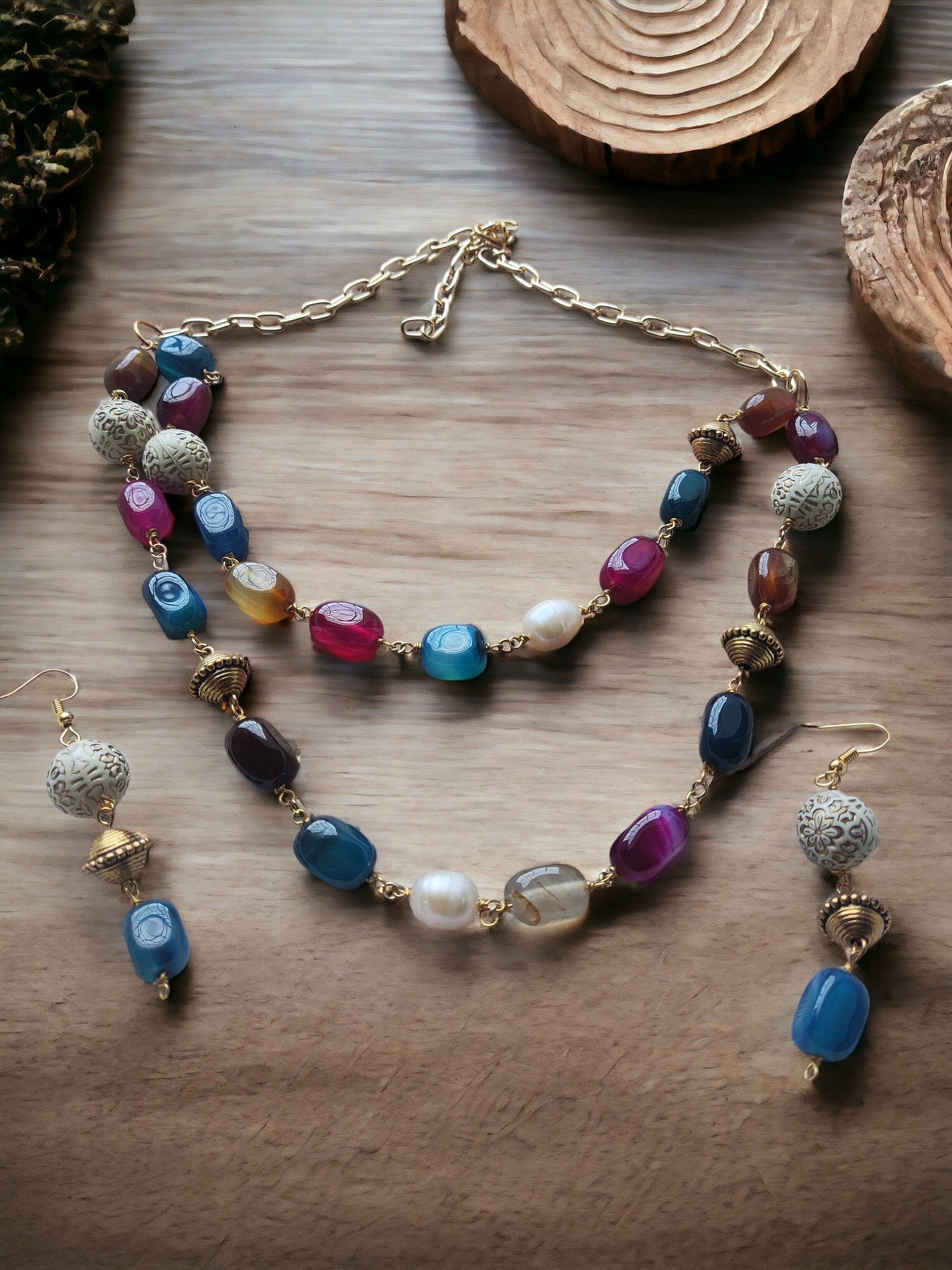 Indulge in the luxurious beauty of our Multi Color Agate Beaded Earrings, featuring stunning pearl and metal accents on a double-layered jewelry set.