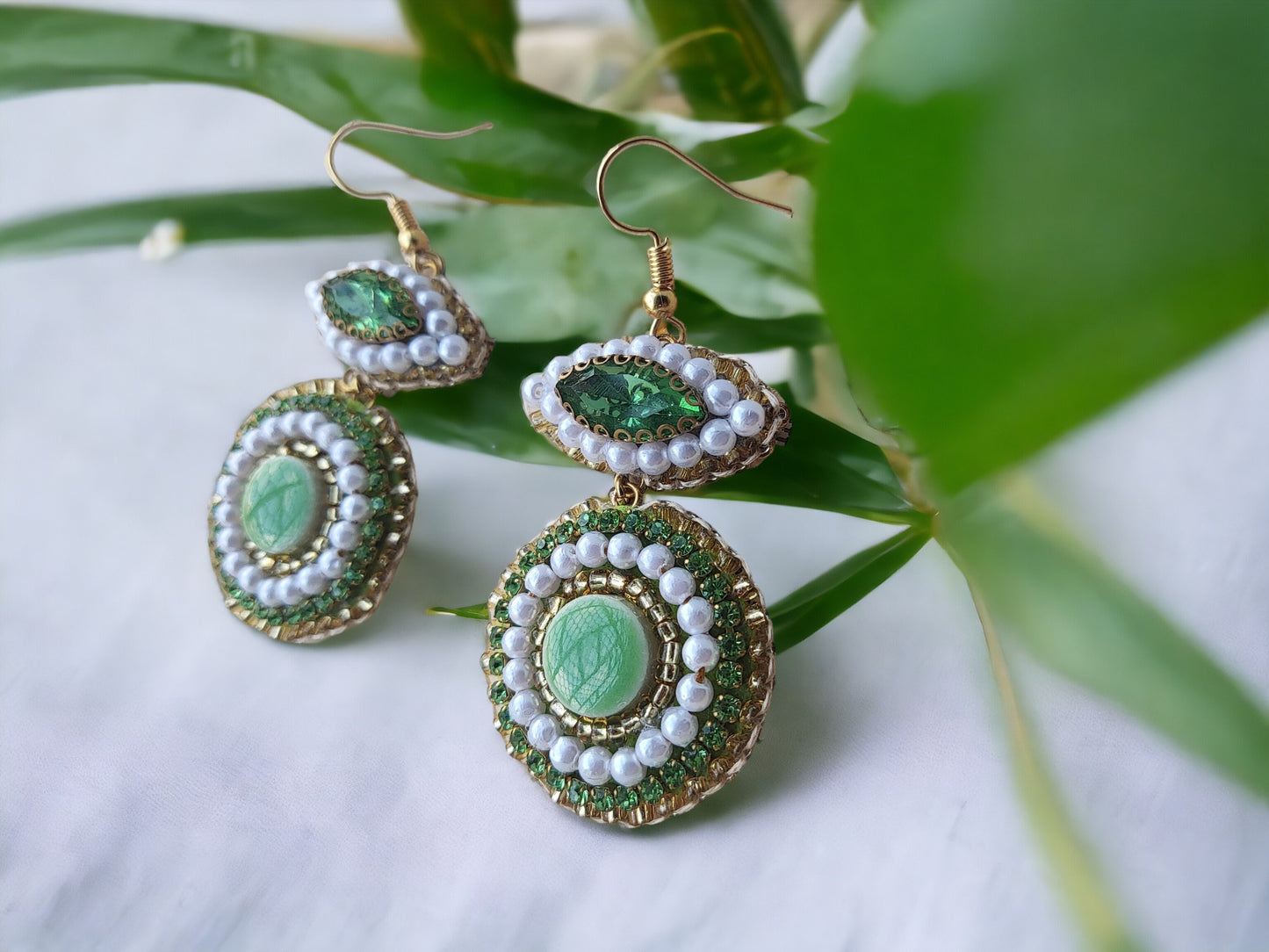 Green Embroidery earrings. Different type of beads and ceramic tile.