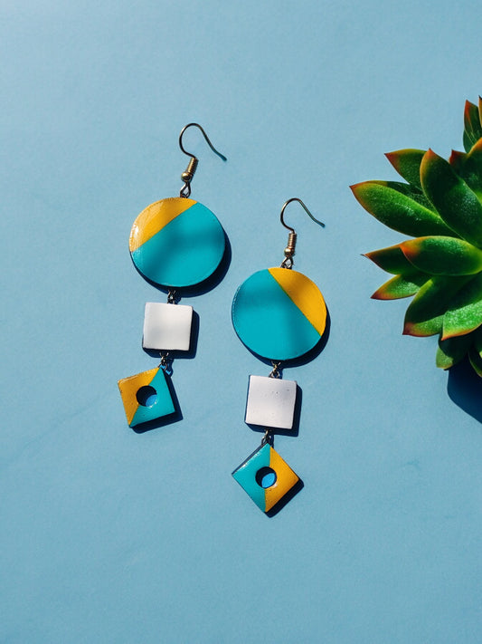 Skillfully handcrafted from terracotta, these earrings showcase a stunning color combination of yellow and teal.