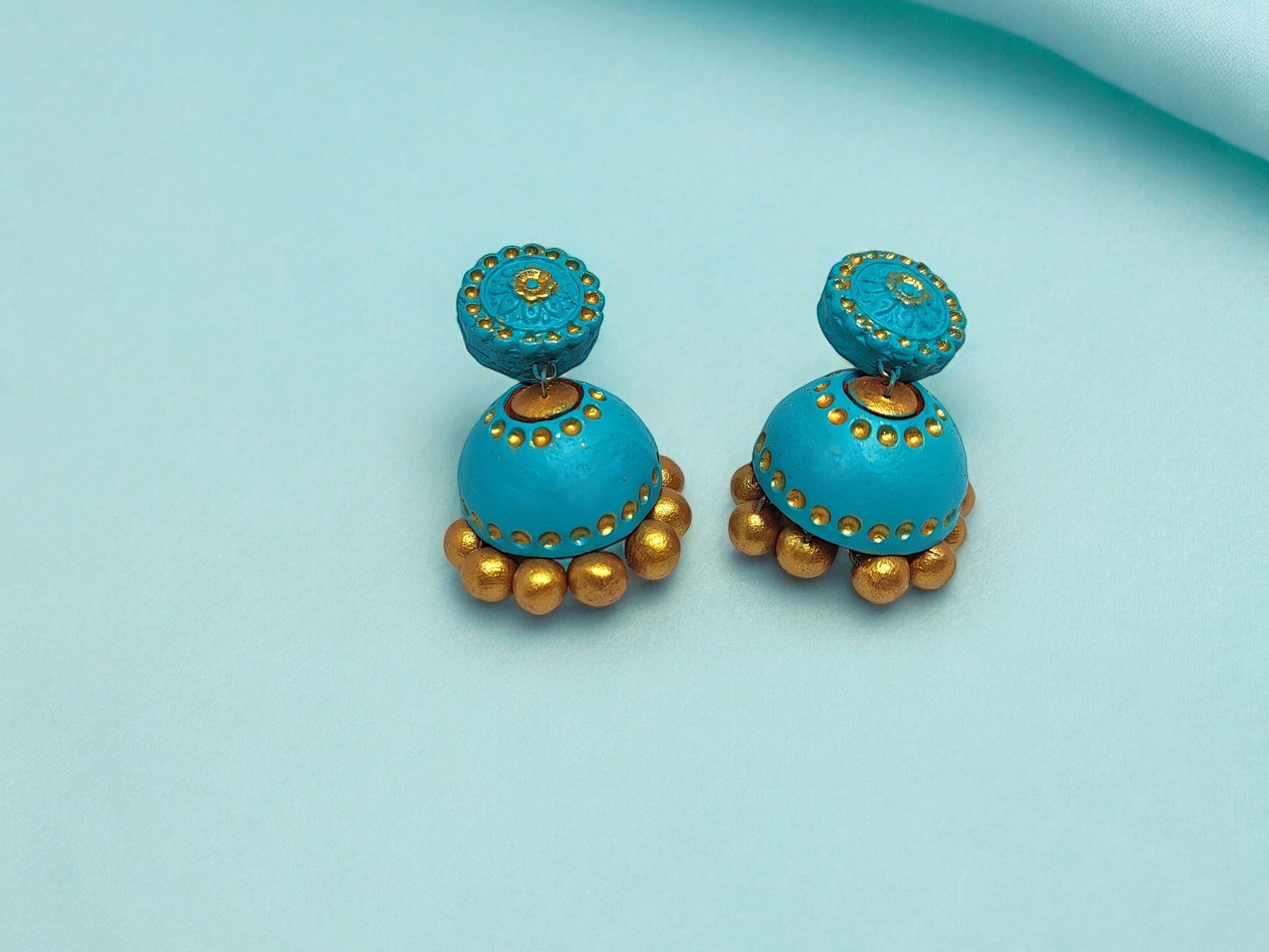 Add a pop of color and personality to any outfit with these turquoise blue terracotta earrings. Handcrafted with a playful touch, these earrings are both stylish and unique. Perfect for any occasion, these earrings are sure to make a statement (and maybe a few heads turn)!