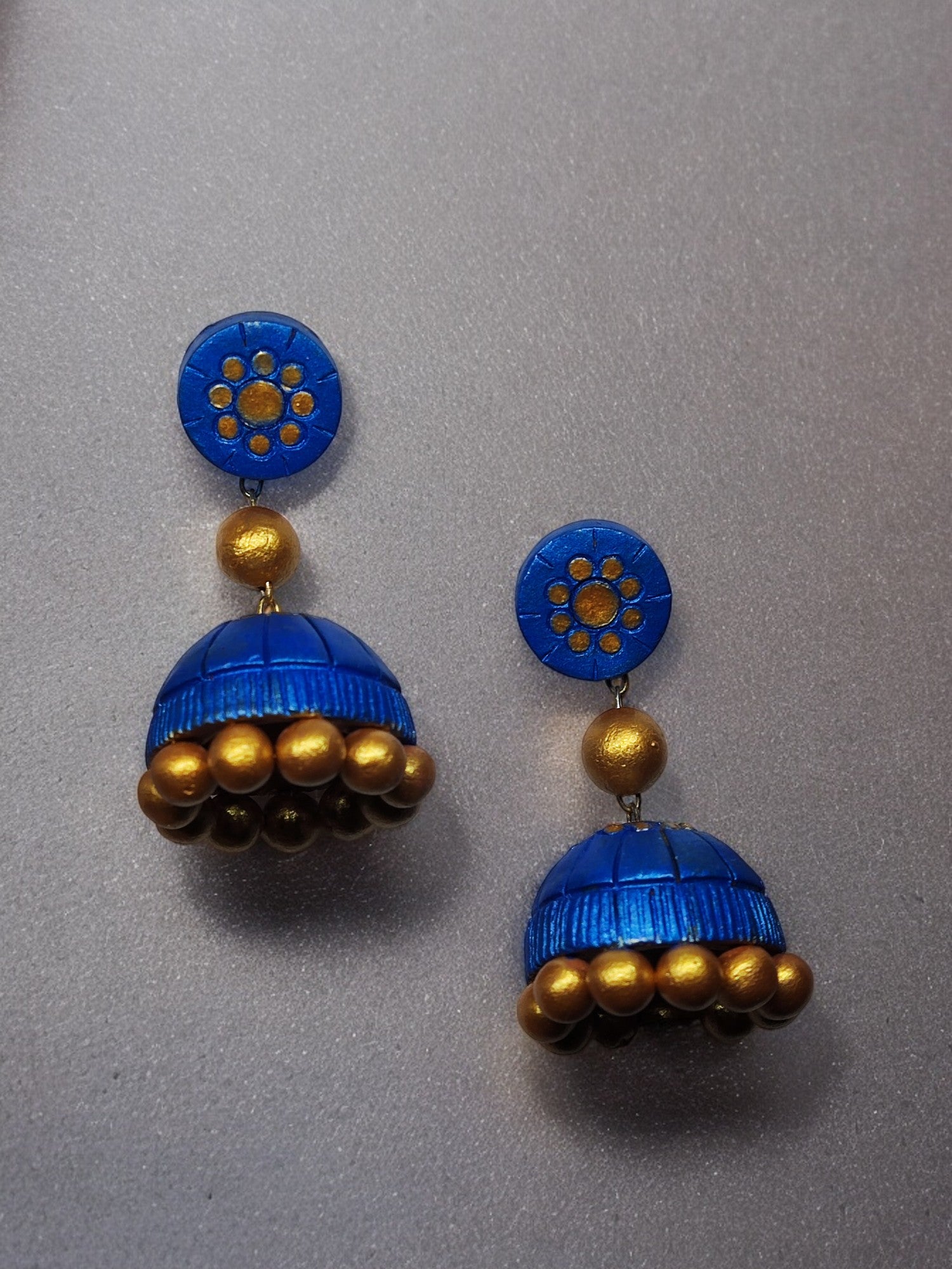 Add a touch of elegance to your outfit with these beautiful Royal Blue Terracotta Jhumka Earrings. Handcrafted with intricate detailing, these earrings are the perfect blend of traditional and modern styles. Made with high-quality materials, they are durable and lightweight, ensuring comfort and style all day long.