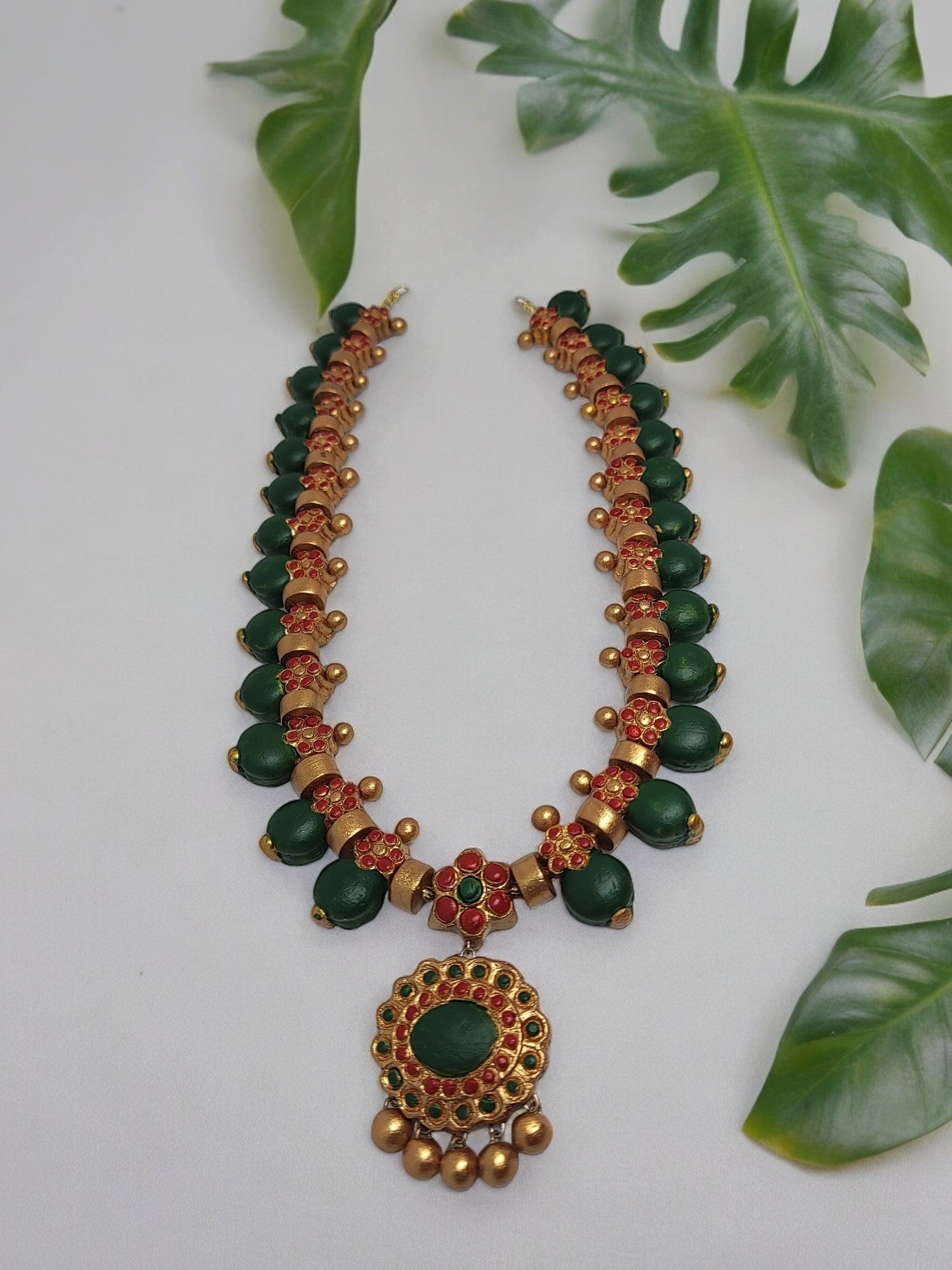 This Aadarshini Terracotta Grand Jewelry set is a must-have for any fashion-forward individual. Handcrafted from high-quality terracotta, this set boasts intricate designs and vibrant colors that are sure to make a statement. Perfect for any occasion, add a touch of elegance and culture to your wardrobe with this unique jewelry set.