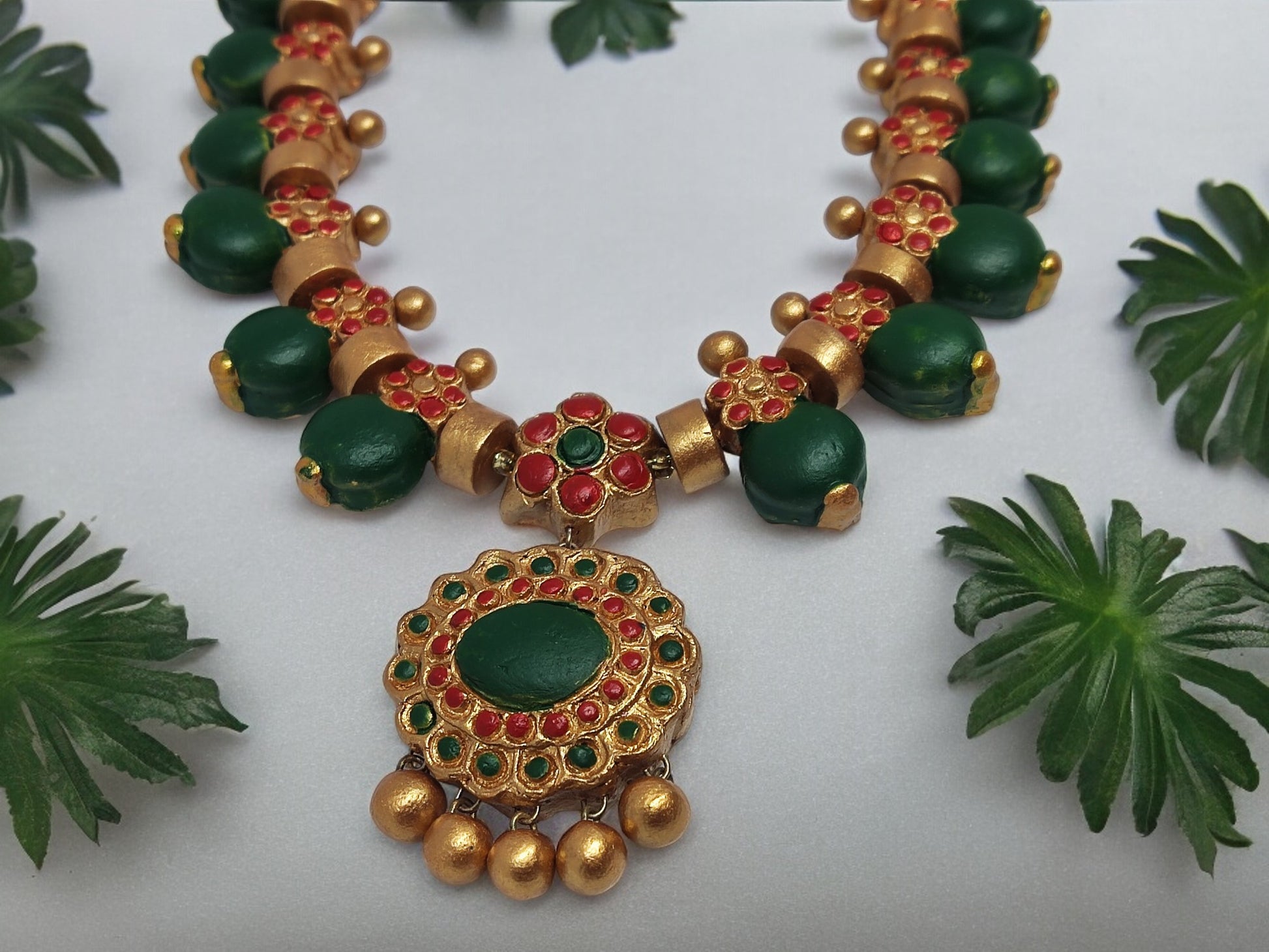 This Aadarshini Terracotta Grand Jewelry set is a must-have for any fashion-forward individual. Handcrafted from high-quality terracotta, this set boasts intricate designs and vibrant colors that are sure to make a statement. Perfect for any occasion, add a touch of elegance and culture to your wardrobe with this unique jewelry set.