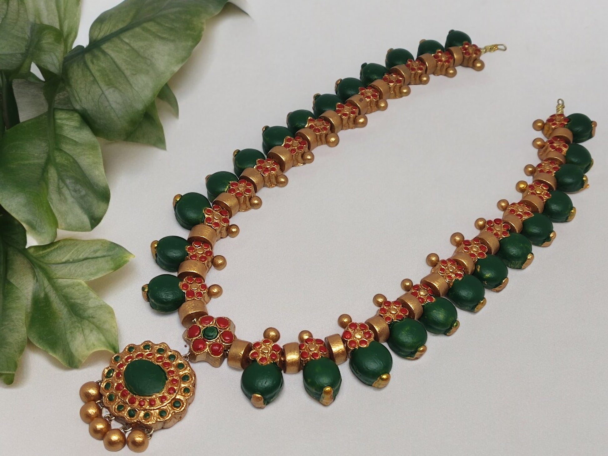 This Aadarshini Terracotta Grand Jewelry set is a must-have for any fashion-forward individual. Handcrafted from high-quality terracotta, this set boasts intricate designs and vibrant colors that are sure to make a statement. Perfect for any occasion, add a touch of elegance and culture to your wardrobe with this unique jewelry set.