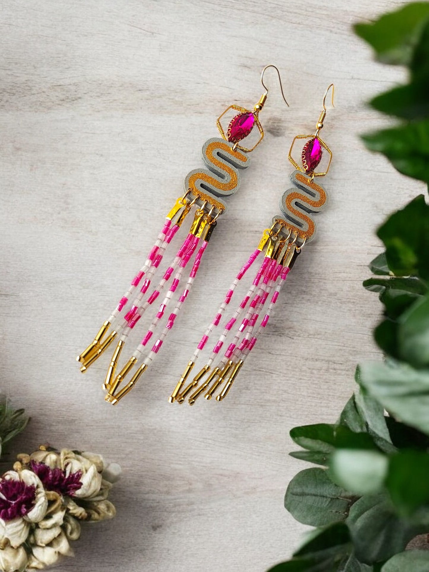 Elevate your style with the Long Beaded Earrings. Crafted with intricate beading, these earrings exude an air of sophistication and luxury. The elongated design adds a touch of elegance to any outfit, making them the perfect accessory for any occasion. Upgrade your jewelry collection with these exclusive earrings.