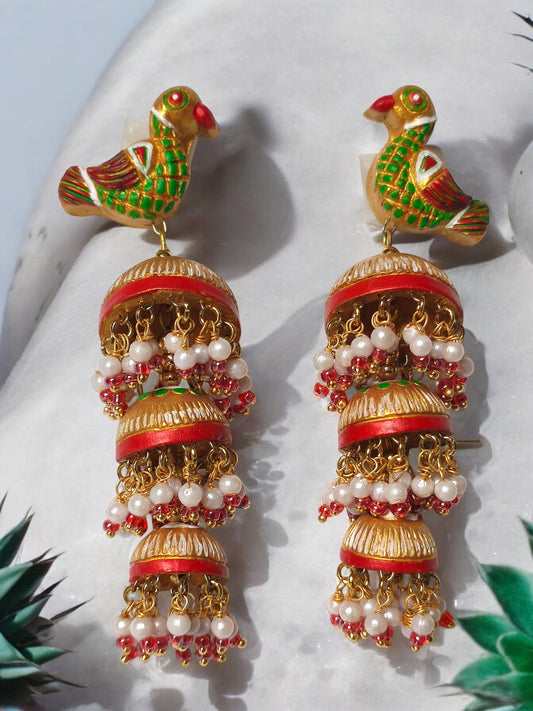 Expertly crafted with three layers of terracotta, these Parrot Motif Jhumkas add a touch of traditional elegance to any outfit. The intricate parrot design is sure to catch the eye, while the terracotta material makes them lightweight and comfortable to wear. Perfect for any occasion, these Jhumkas are a must-have for any jewelry collection.