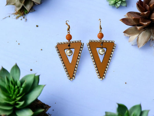 Introduce an air of refinement with our Triangle Wooden Earring. Skillfully crafted from lightweight wood, each pair boasts a uniquely sophisticated triangular design. Enhance your accessory collection with a hint of organic elegance.

