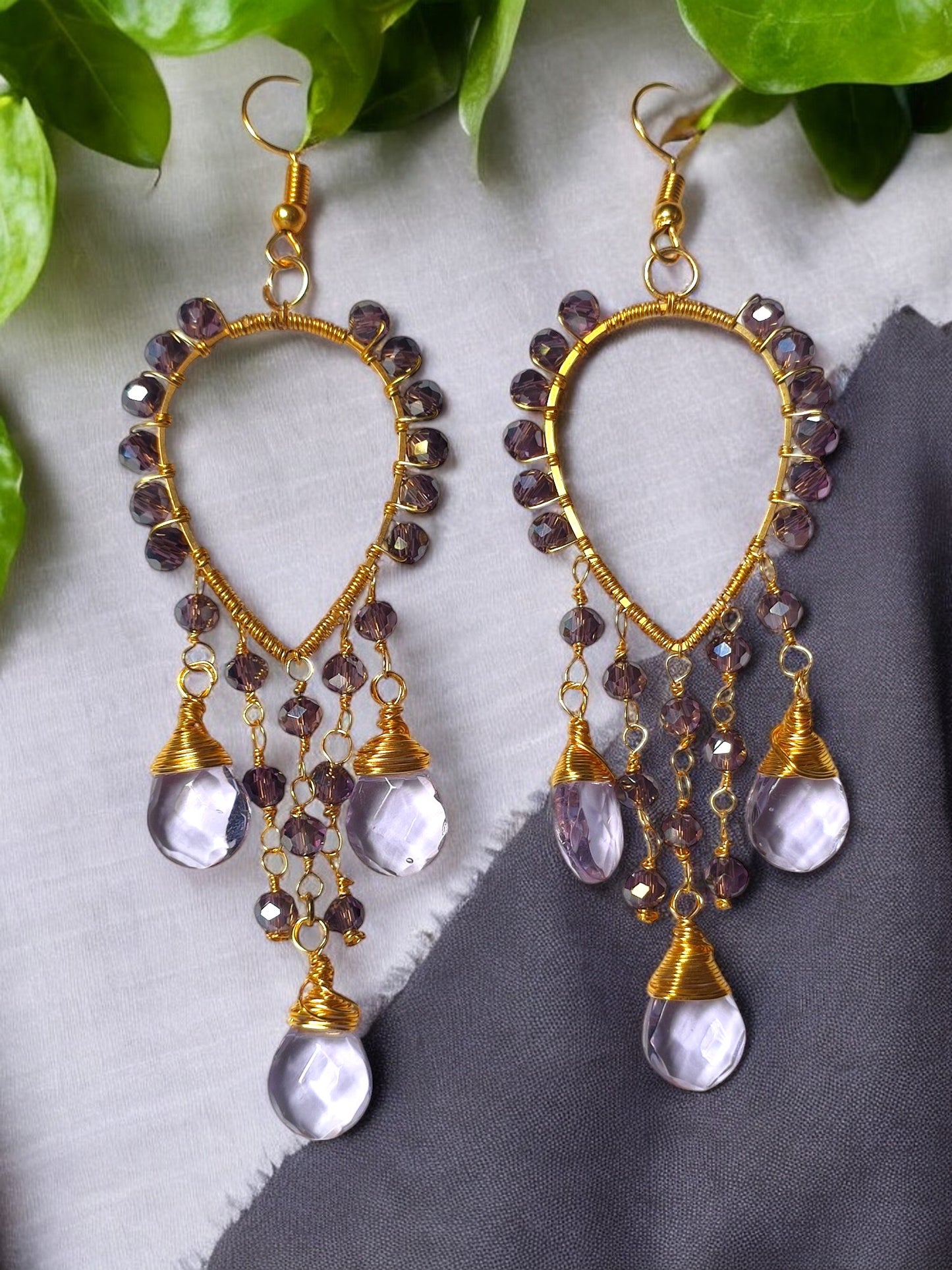 These Voilet Crystal Glass beaded earrings are the perfect blend of elegance and comfort. With their long and lightweight design, they'll add a touch of sophistication to any outfit without weighing you down. The wire wrap adds a modern touch to this timeless accessory.