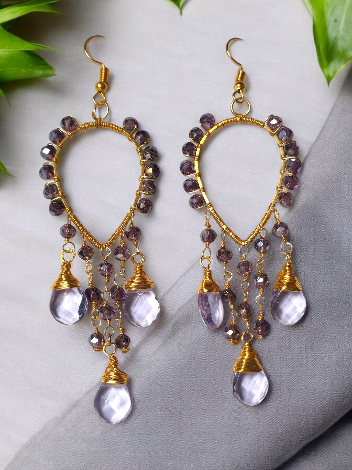 These Voilet Crystal Glass beaded earrings are the perfect blend of elegance and comfort. With their long and lightweight design, they'll add a touch of sophistication to any outfit without weighing you down. The wire wrap adds a modern touch to this timeless accessory.