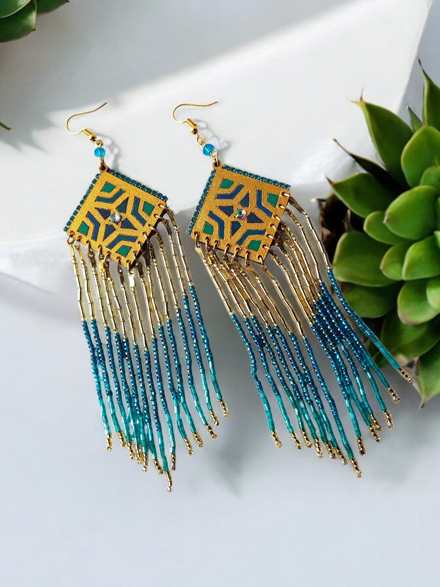 These Bella Long Beaded Earrings in blue gradience shades will add a touch of elegance to any outfit. The beautiful blue shades transition seamlessly, creating a unique and eye-catching design. Make a statement and elevate your look with these stunning earrings.